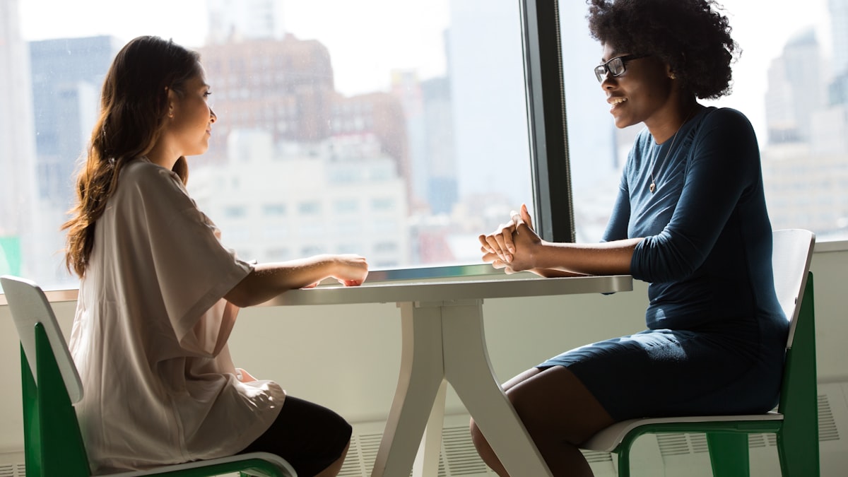 Two people in a one-on-one interview across a table