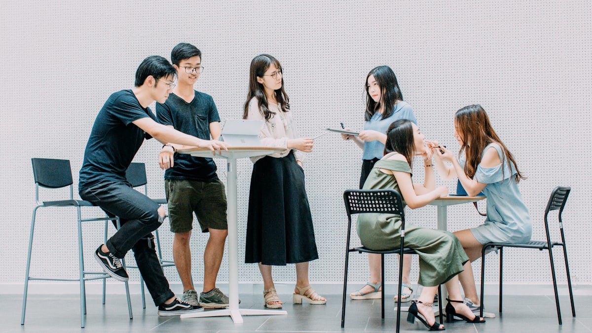 A group of students collaborating on a project around a shared table